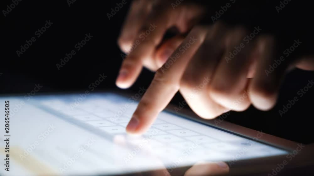 Closeup fingers typing texting a message on tablet. Network, communication, technology concept Closeup fingers typing texting a message on tablet. Network, communication, technology concept