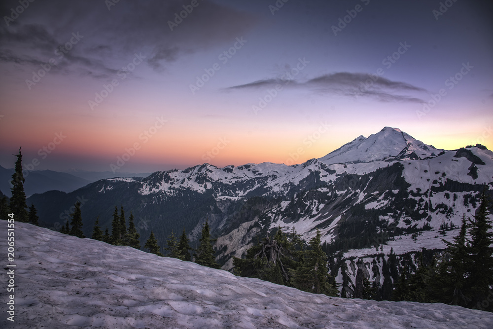 Mt. Baker at sunset with snow pack and blue red sky