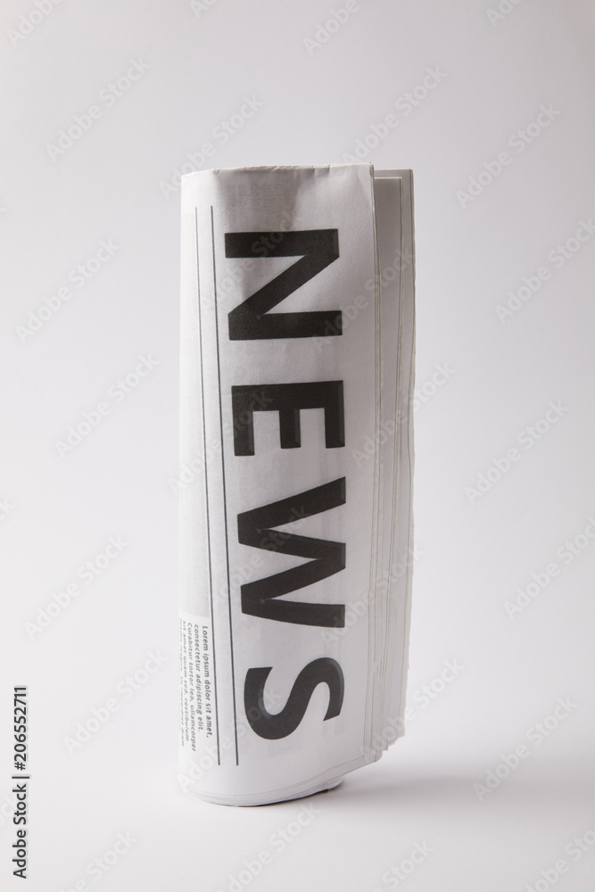 rolled daily newspaper on white background rolled daily newspaper on white background