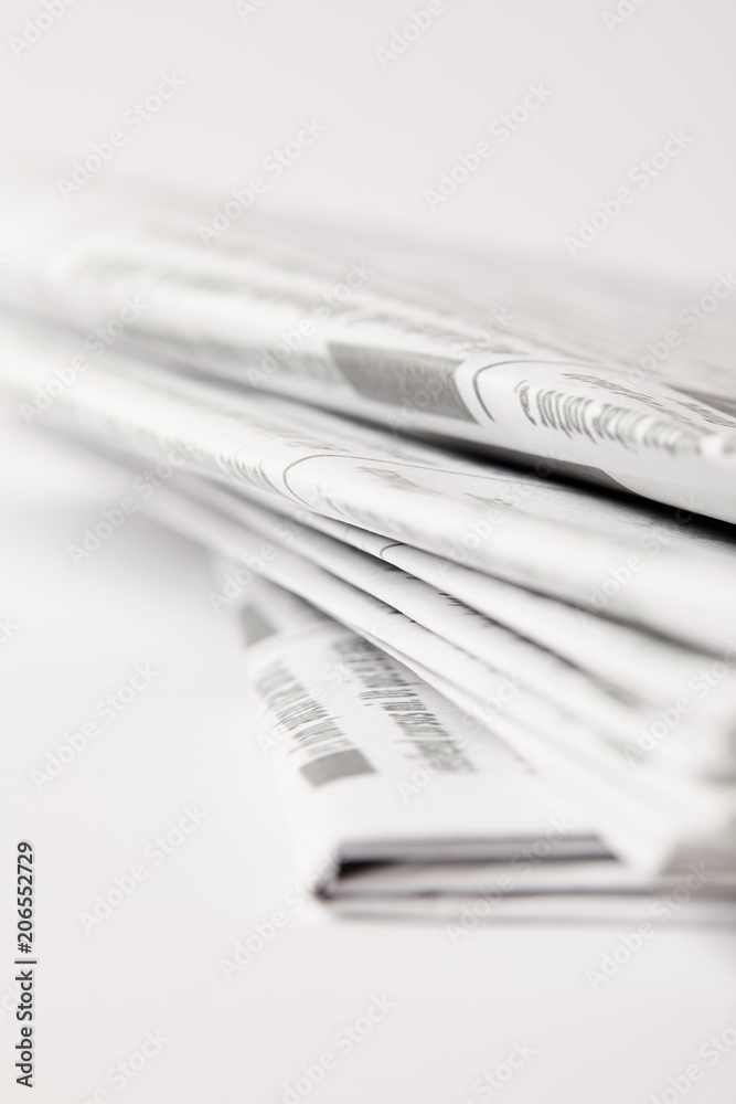 close up of pile of daily newspapers, selective focus on white close up of pile of daily newspapers, selective focus on white