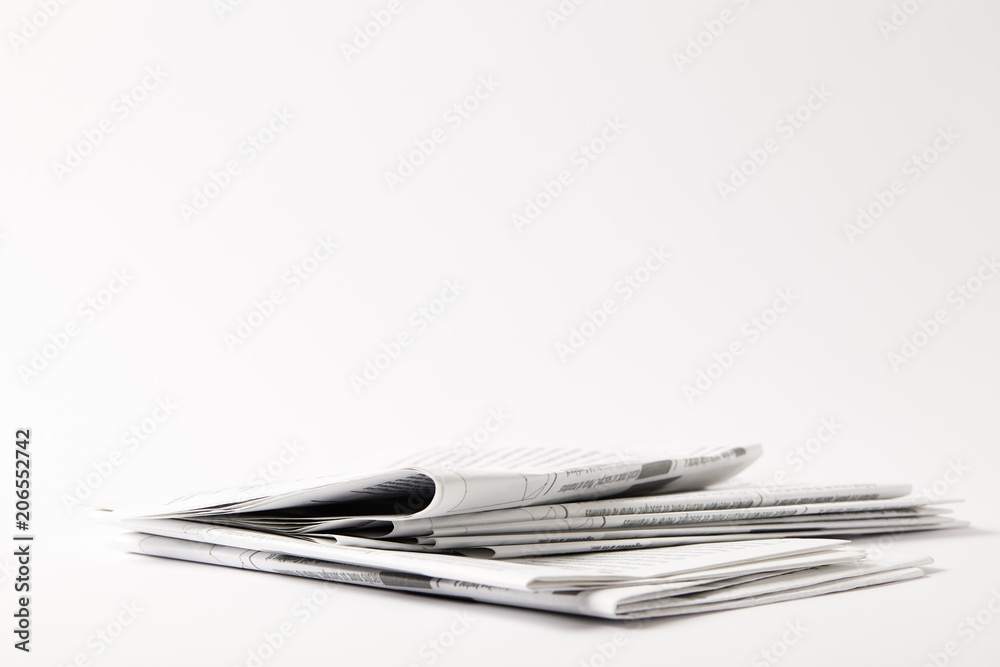 pile of business newspapers, isolated on white with copy space pile of business newspapers, isolated on white with copy space