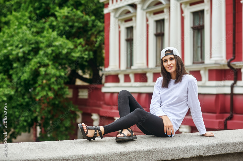 Portrait of a young woman in the city .Women's casual clothes .