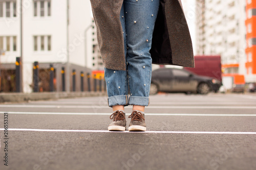 young woman legs on asphalt on the street