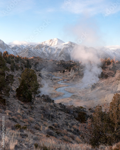 Mist rises up above a steaming river of geothermal water
