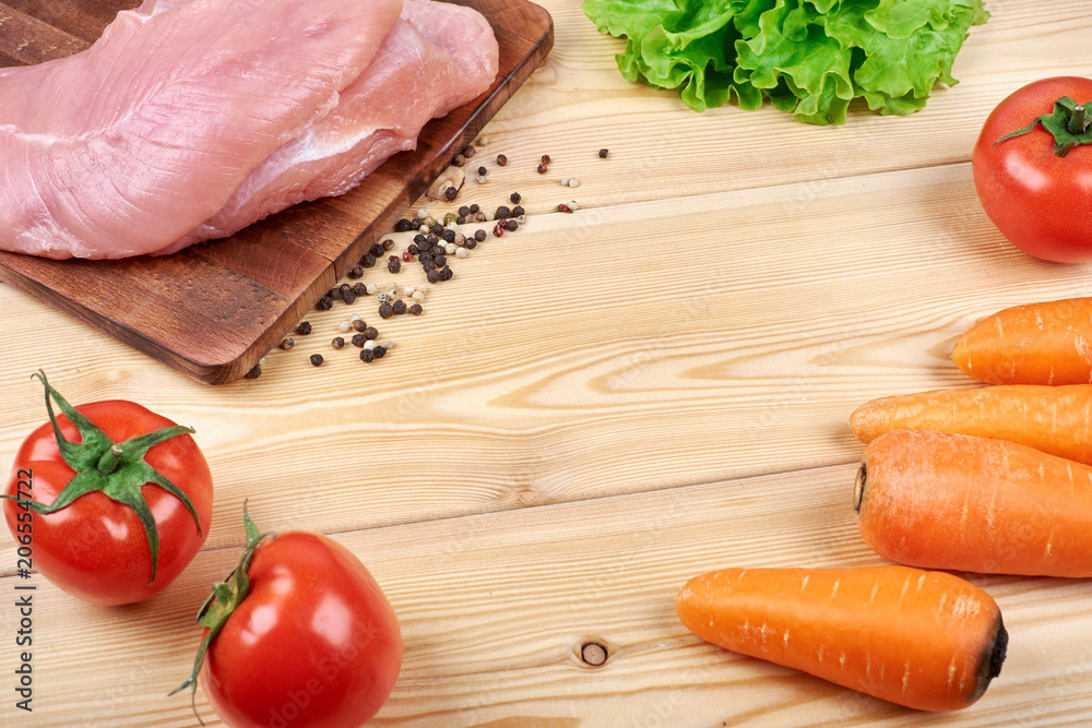 Frame of fresh vegetables and dietary meat on wooden background. Healthy natural food on table with copy space. Cooking ingredients top view, mockup for recipe or menu Frame of fresh vegetables and dietary meat on wooden background. Healthy natural food on table with copy space. Cooking ingredients top view, mockup for recipe or menu