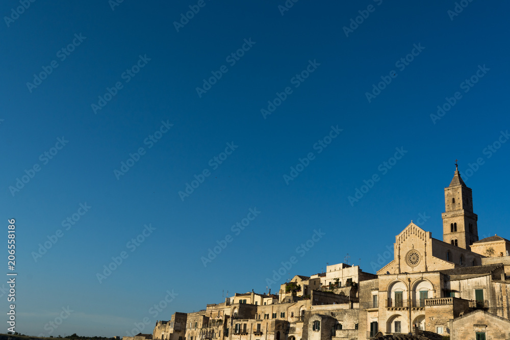 Horizontal View of the City of Matera at Sunset on Clear Blue Sky Background