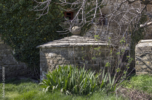 Grisignana, Central Istria, Croatia - Medieval rainwater tank in an old stone house backyard  photo