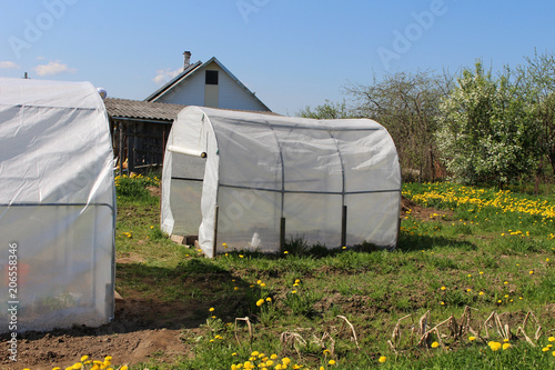 Plastic greenhouses for growing vegetables on the farm field © Николай Григорьев