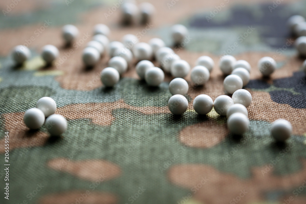 airsoft balls on the background of camouflage fabric airsoft balls on the background of camouflage fabric