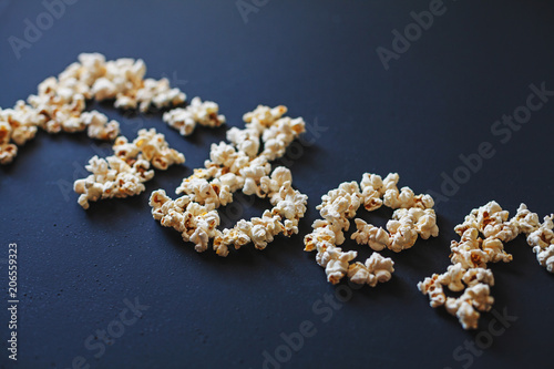 A word "Fiber" made of fresh popcorn on dark matte painted surface