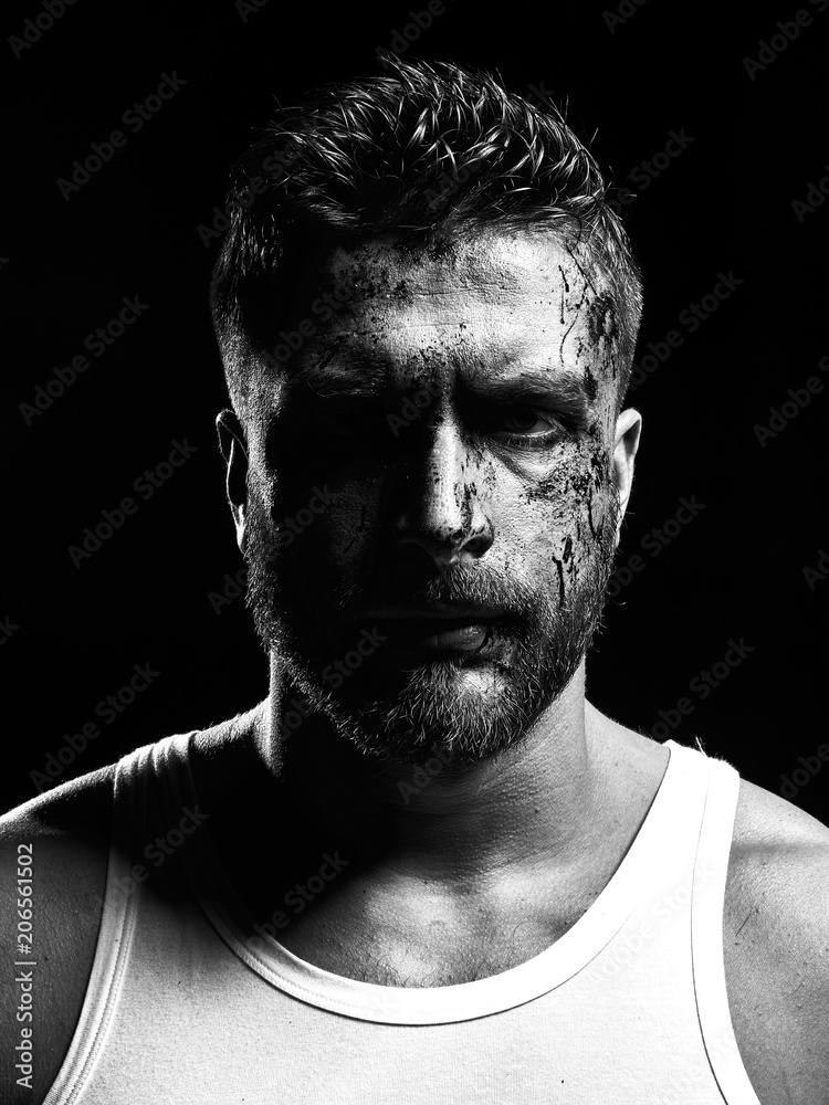 Monochrome portrait of a strong man with a beard. He looks at the camera with different emotions. 