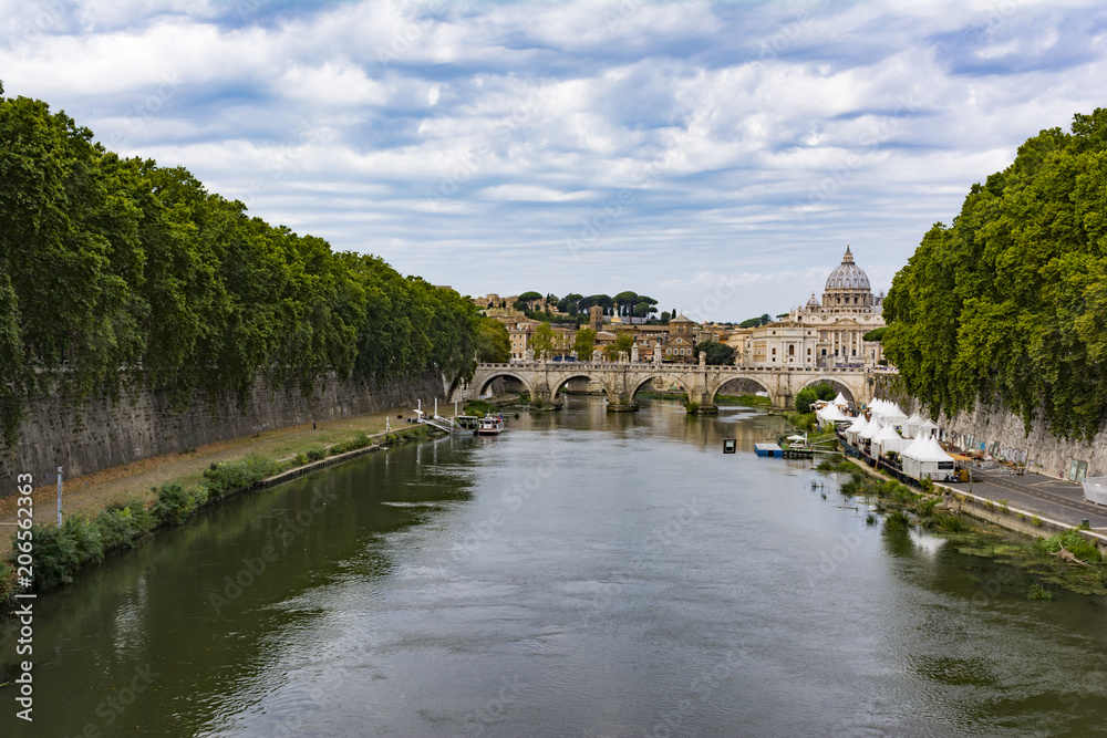 View of Tiber river with Saint Peter's Dome at distance in Rome, Italy