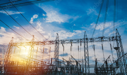 Sunset behind substation towers with blue sky photo