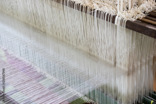 Closed up of loom with white thread background photo
