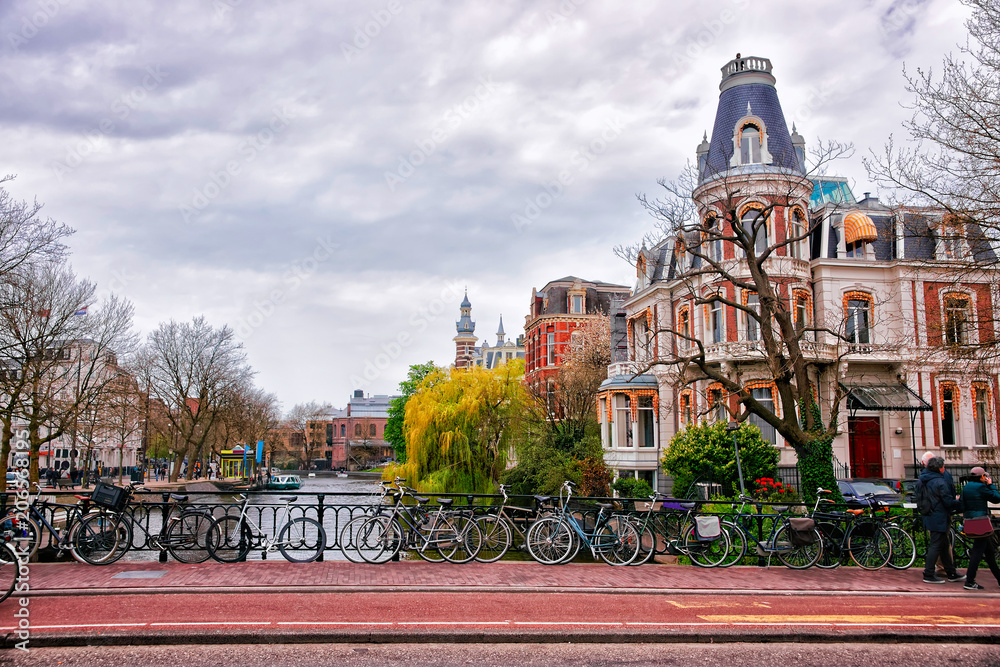 Obraz premium Bicycles at canal of Amstel River in Amsterdam
