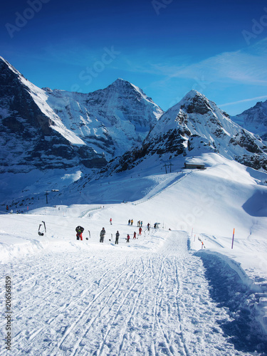 Skiers in winter sport resort Swiss Alps Maennlichen photo