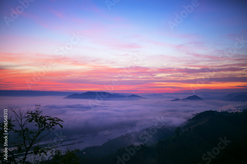 Landscape twilight mist at the dawn of a high mountain pass to the Mekong river the between Thai - Laos.