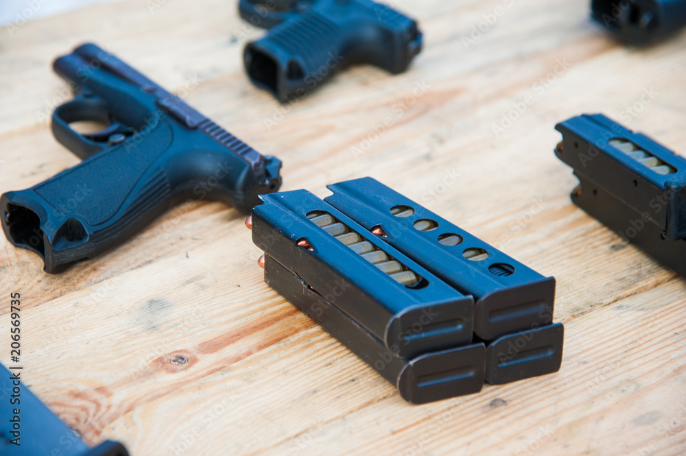 Gun with ammunition on wooden background Gun with ammunition on wooden background