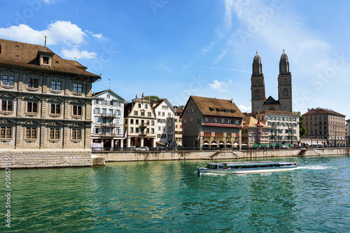 River cruiser at Limmat River Grossmunster Church in Zurich