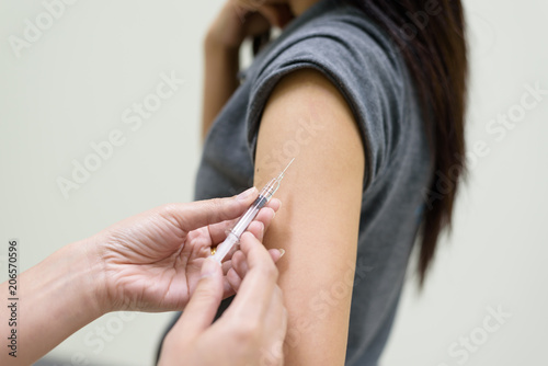 Doctor hand injected vaccination for woman.Treatment and protection vaccine concept.