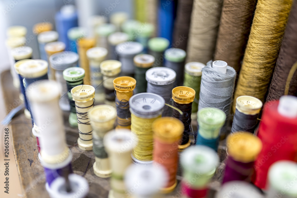 Colourful cotton bobbins and thread in a traditional tailors shop Colourful cotton bobbins and thread in a traditional tailors shop