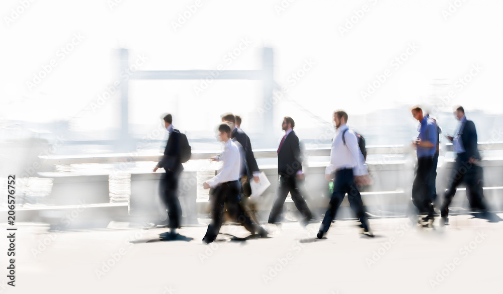 Group of business people walking over London bridge to the City of London. Early morning rush, modern life concept Group of business people walking over London bridge to the City of London. Early morning rush, modern life concept
