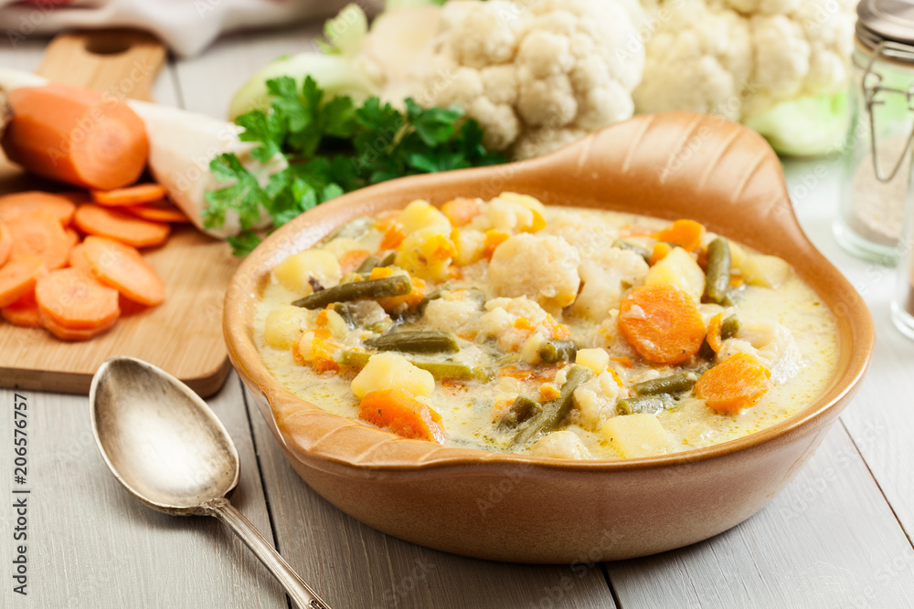 Vegetable soup with ingredients carrot, cauliflower, potato and Vegetable soup with ingredients carrot, cauliflower, potato and