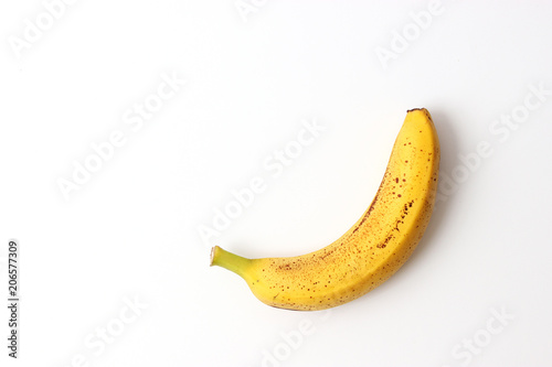 a ripe and sweet banana with dots on a light background. minimalism.