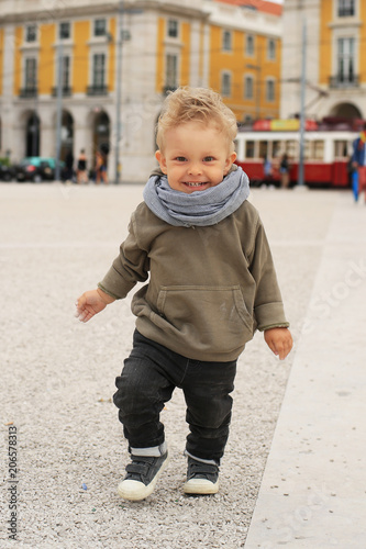 Cute little boy walking around the square in Lisbon © Zarya Maxim