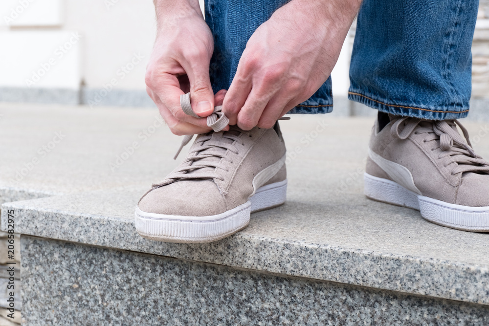 Men's hands tying laces ready for walking