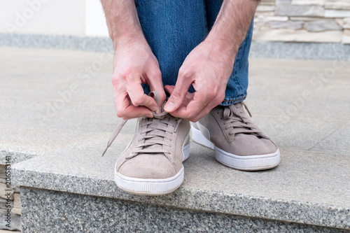 Men s hands tying laces ready for walking