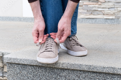 Men's hands tying laces ready for walking