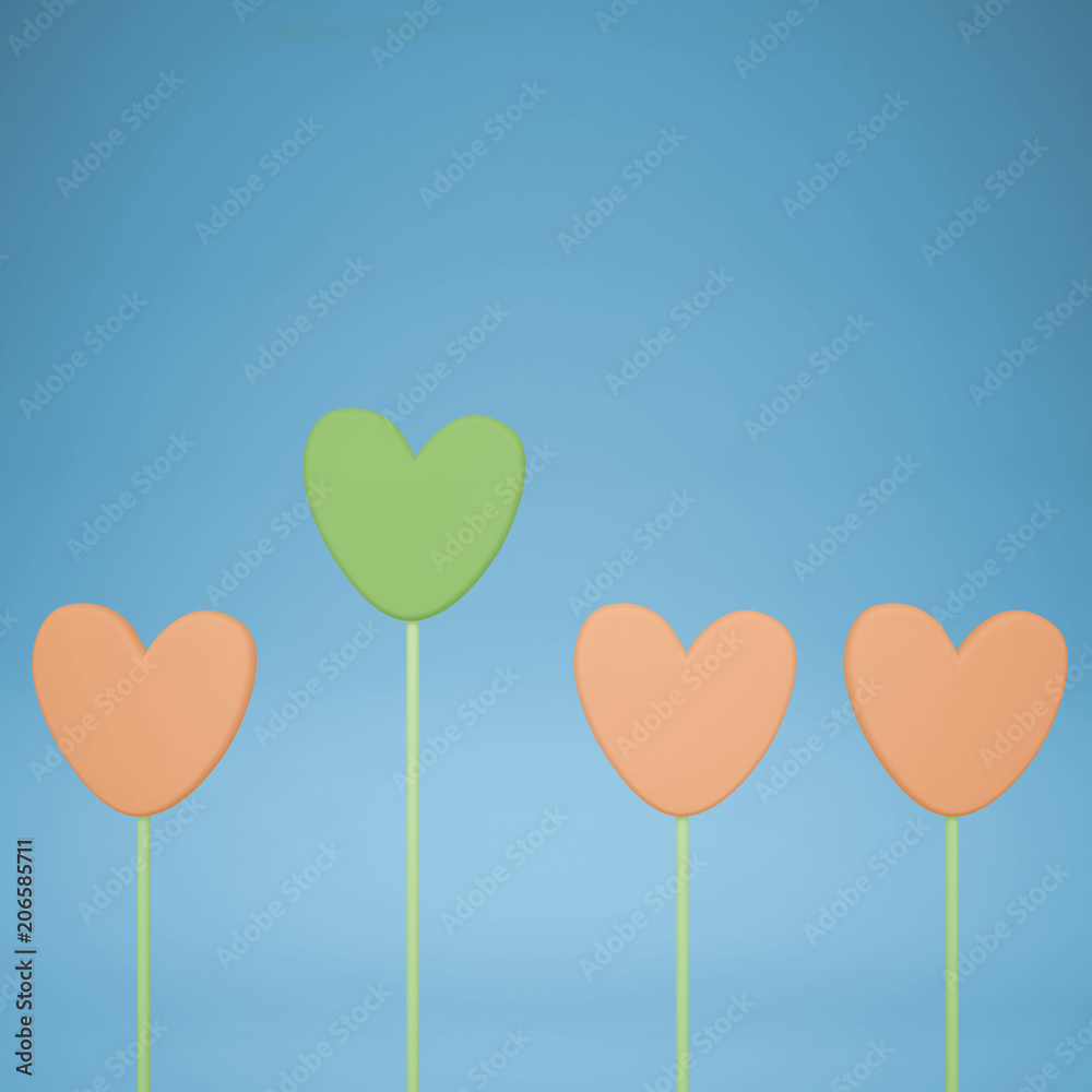 Minimal love and care concept idea, green and orange heart shape candies on blue pastel background with copy space