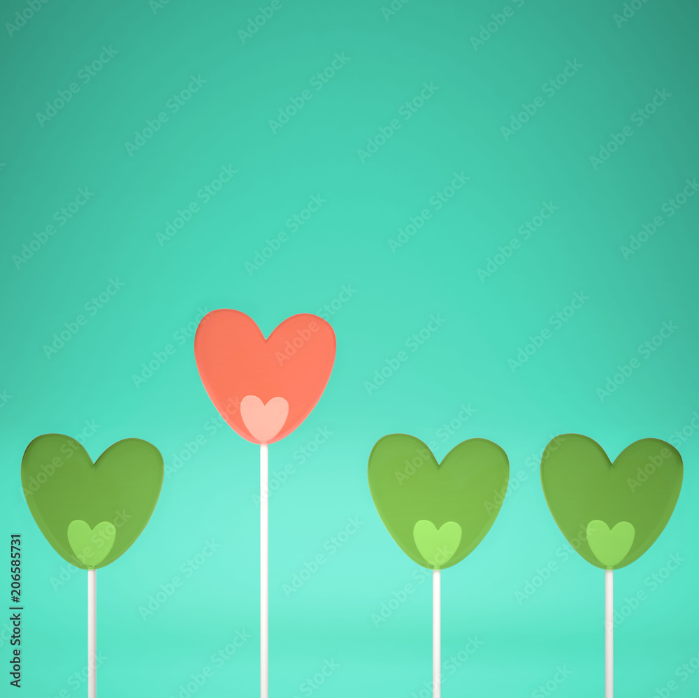 Minimal love and care concept idea, green and pink heart shape candies on turquoise pastel background with copy space
