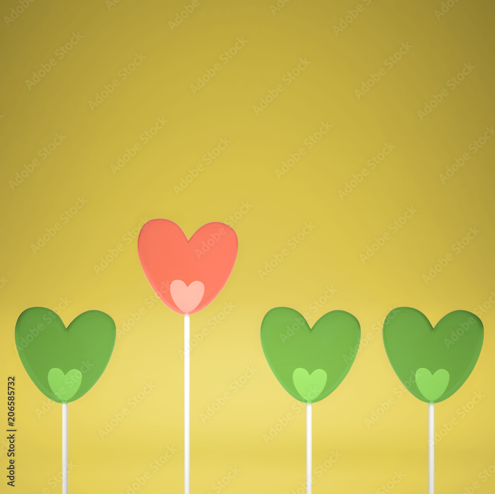 Minimal love and care concept idea, green and pink heart shape candies on yellow pastel background with copy space