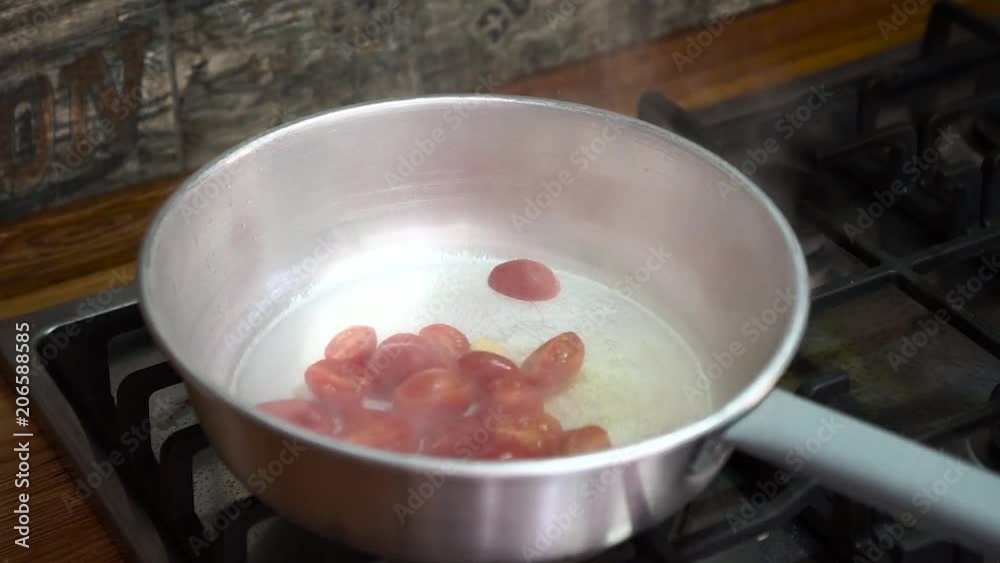 tomatoes in a pot cooking in slow motion - Preparation of spaghetti with tomatoes - Italian original recipe tomatoes in a pot cooking in slow motion - Preparation of spaghetti with tomatoes - Italian original recipe