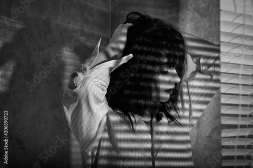 romantic girl in a shirt with shades of blinds on the body