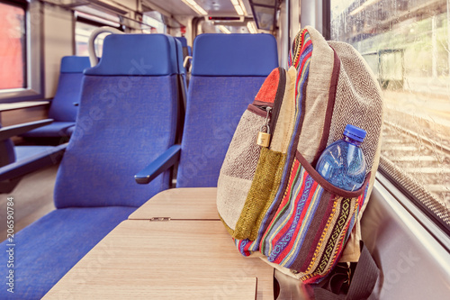 Backpack on the train near the window. Travel conceptual image.