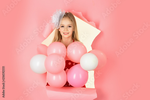 beautiful little girl with balloons on pink background © Volodymyr