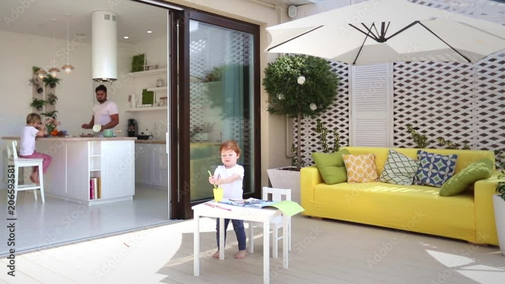 casual domestic lifestyle of family in modern home with sliding door and patio area