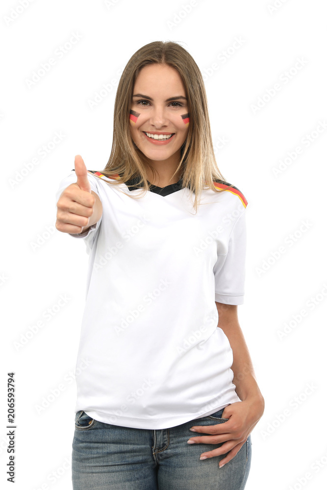 Hübsche blonde Frau mit Deutschland Makeup und Trikot lacht und Daumen hoch Hübsche blonde Frau mit Deutschland Makeup und Trikot lacht und Daumen hoch