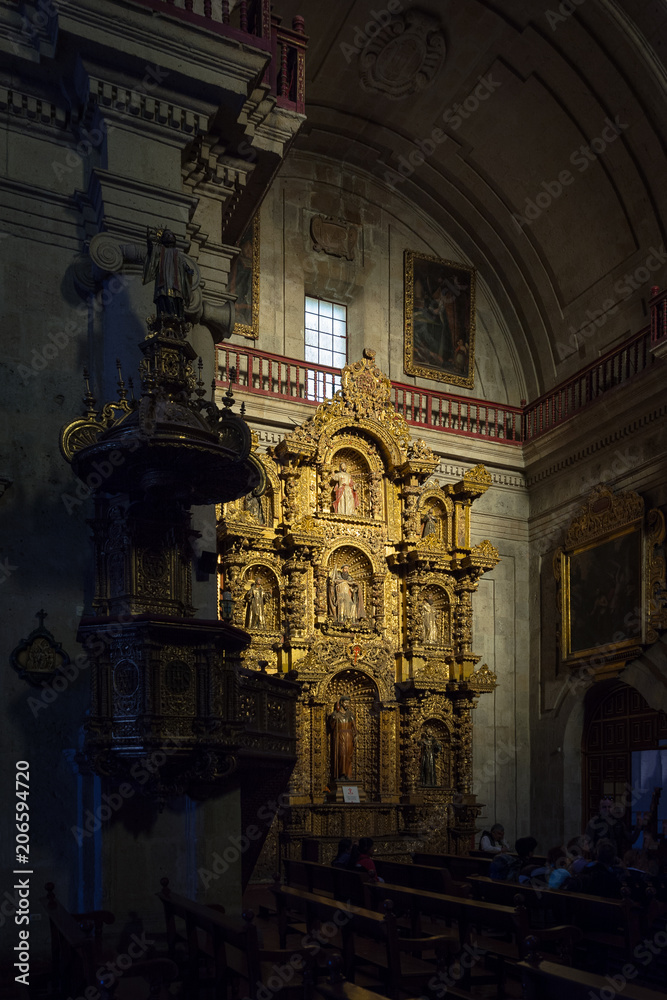 Altarpiece lightened by a beam of sunshine in the baroque church of the Society of Jesus, Arequipa 