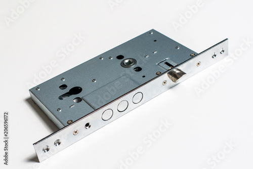 Fotografie Mechanical lock with a key against white background