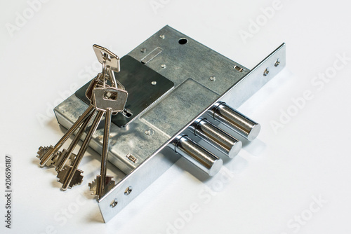 Mechanical lock with a key against white background photo