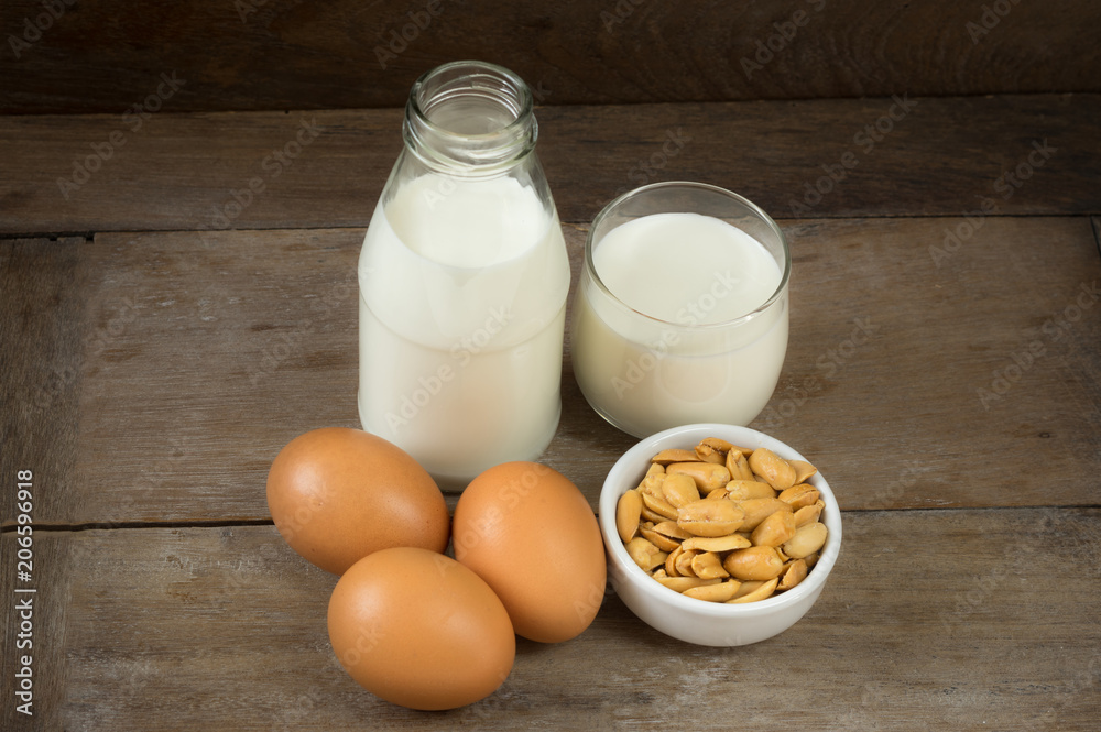 Nut in cup with milk bottle and eggs. Nut in cup with milk bottle and eggs.