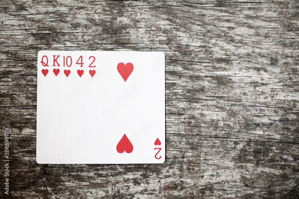 poker hand: flush. playing cards on wooden table