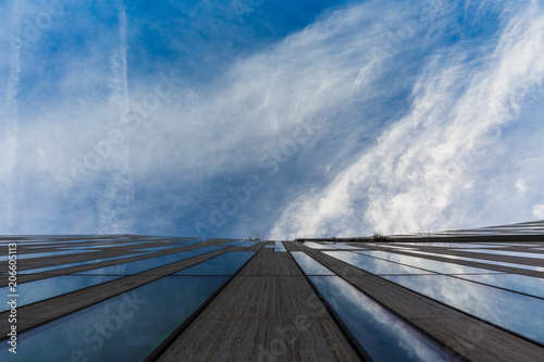 Building from glass and concrete with dramatic sky © rninov
