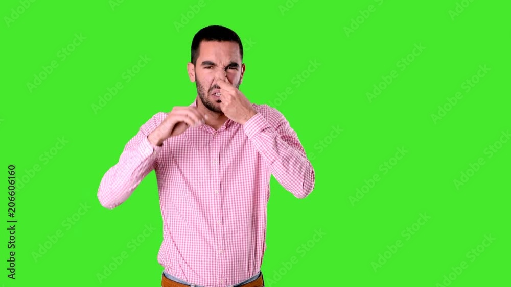 Concerned young man with a gesture of bad smell Concerned young man with a gesture of bad smell
