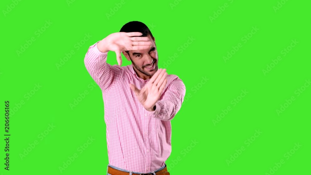 Concentrated young man trying to focus with his hands. Frame gesture - Chroma background