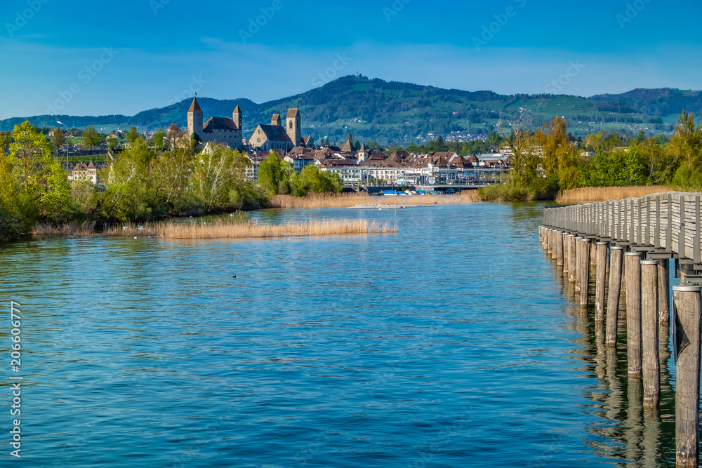 The Holzsteg, a wooden pedestrian bridge crossing the Zurich Lake (Obersee) Part of the eastern branch of the Way of Saint James. The Rapperswil castle is in the background. Switzerland The Holzsteg, a wooden pedestrian bridge crossing the Zurich Lake (Obersee) Part of the eastern branch of the Way of Saint James. The Rapperswil castle is in the background. Switzerland